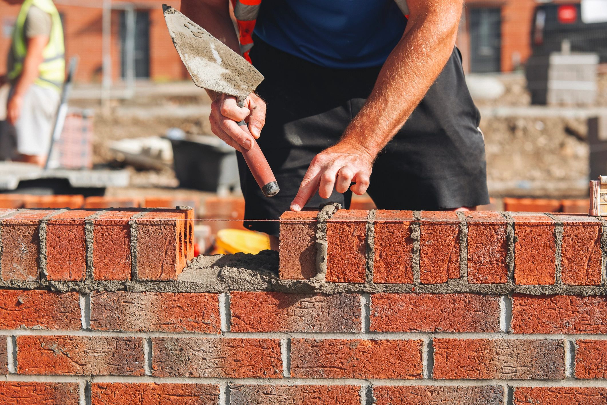 Bricklayer laying bricks