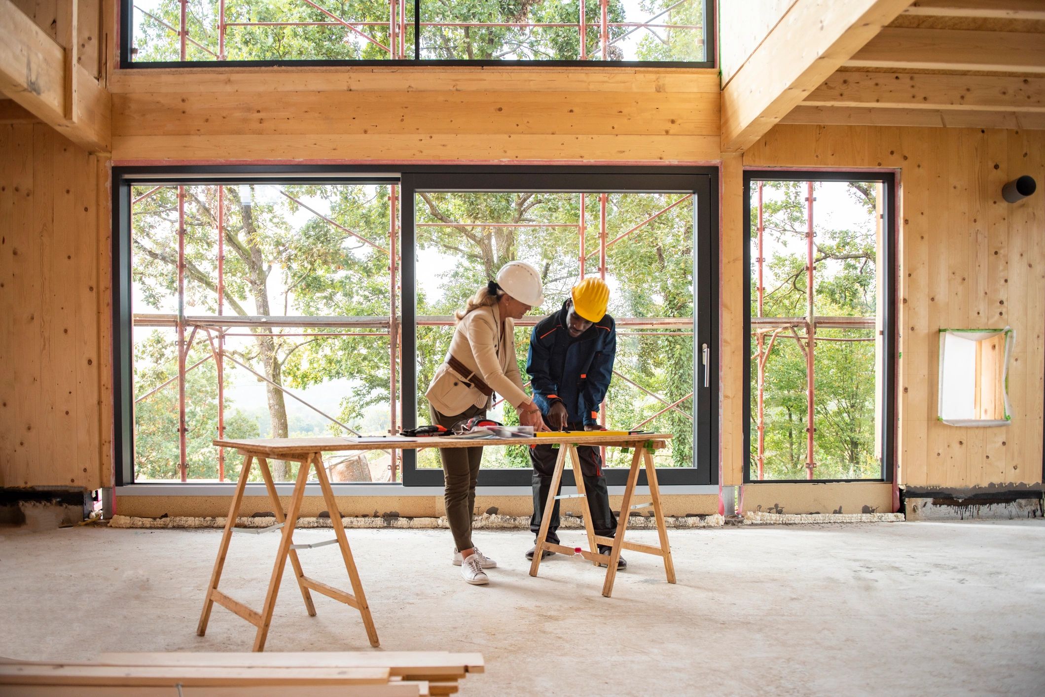 Workers at workbench in timber frame building